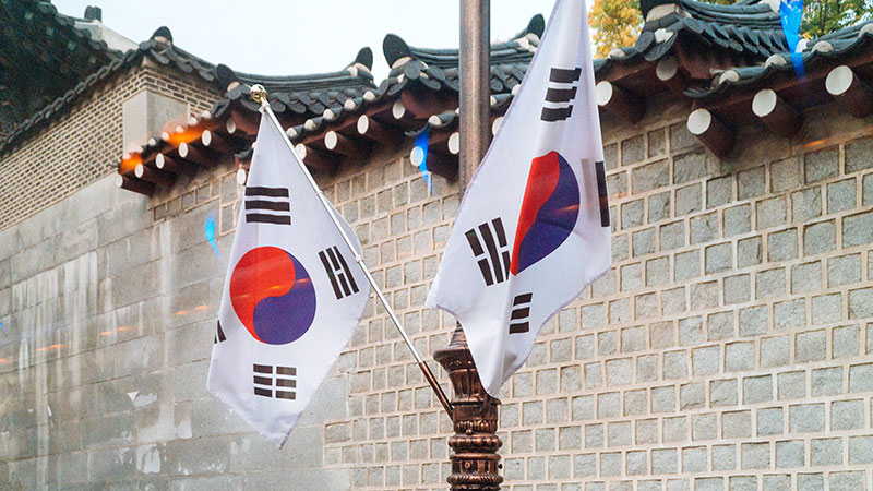 two flags in front of wall