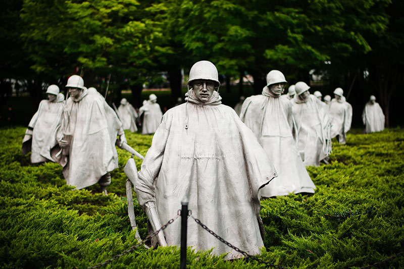 white statues of soliders in field