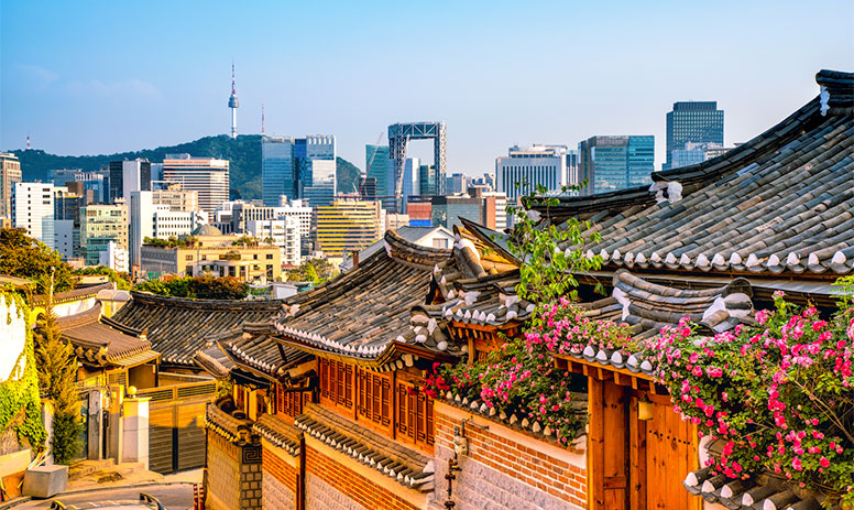 traditional buildings in front of modern skyline